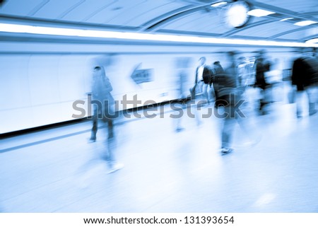 business people walk at subway station abstract blur