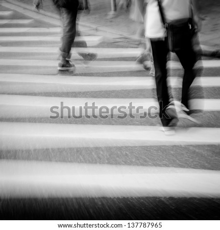 people walking on big city street, blurred motion zebra crossing abstract