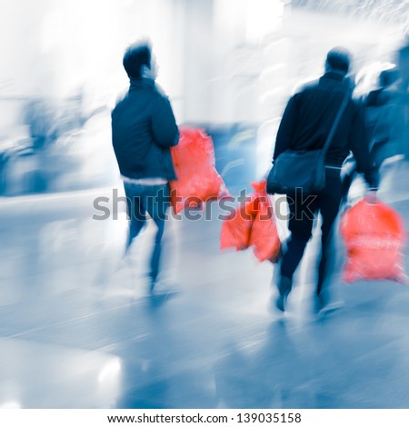 city business people shopping inside a mall with bag, blur motion