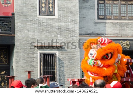 FOSHAN,CHINA- FEB. 19: Chinese Lion dance perform. Lion dance is a form of traditional dance in Chinese,in which performers mimic a lion's movements in a lion costume.  Foshan, Feb. 19, 2012.