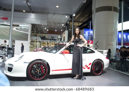 GUANGZHOU, CHINA - DEC 27: Fashion Model on porsche 911car at the 8th China international automobile exhibition on December 27, 2010 in Guangzhou China.