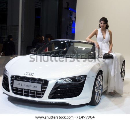 GUANGZHOU, CHINA - DEC 27: Fashion Model on Audi R8 car at the 8th China international automobile exhibition on December 27, 2010 in Guangzhou China.