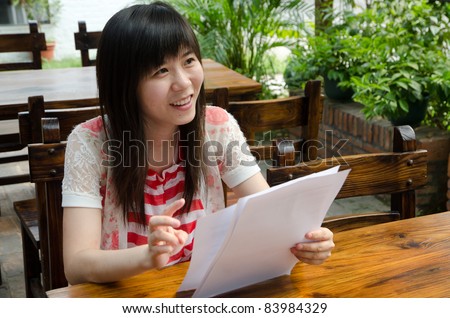 Asian woman on desk with paper