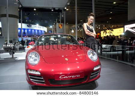 GUANGZHOU, CHINA - DEC 27: Porsche carrera sport car and model on display at the 8th China international automobile exhibition. on December 27, 2010 in Guangzhou China.