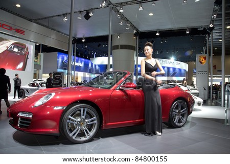 GUANGZHOU, CHINA - DEC 27: Porsche carrera sport car and model on display at the 8th China international automobile exhibition. on December 27, 2010 in Guangzhou China.
