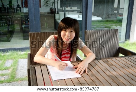 asian woman on desk with paper outdoor