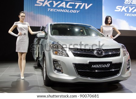 GUANGZHOU, CHINA - NOV 26: unidentified model with Mazda 8 car at the 9th China international automobile exhibition. on November 26, 2011 in Guangzhou China.