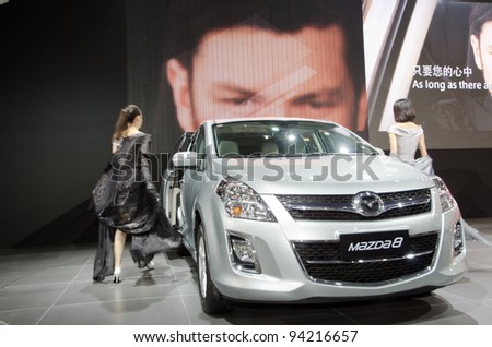 GUANGZHOU, CHINA - NOV 26: unidentified model with Mazda 8 car at the 9th China international automobile exhibition. on November 26, 2011 in Guangzhou China.