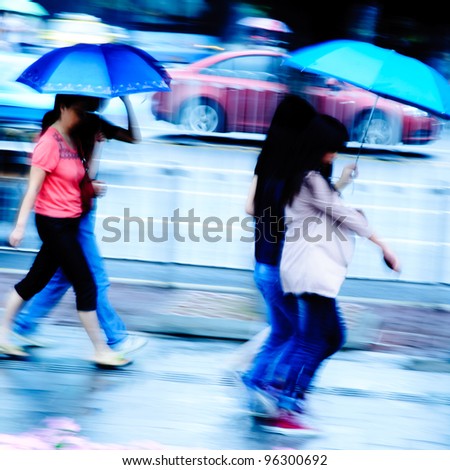 big city people walk on road in rainy day