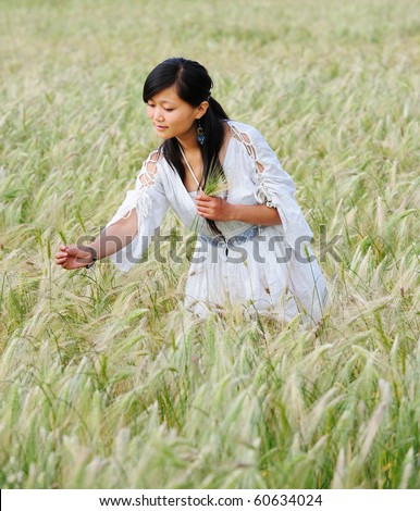 A girl walks in highland barley field.