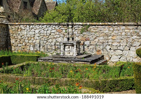 raised Stone garden well in a medieval English walled garden