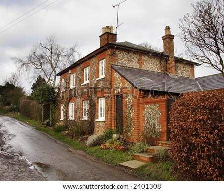 Winter scene of a Brick and Flint House on a Country Lane in Rural England
