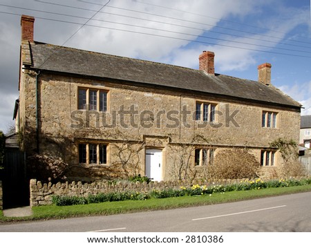 Winter sunshine on a Natural Stone Mullion windowed English Village House