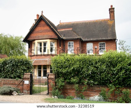 Red Brick and Pantiled Village House in Rural England with a Wall and Hedge to the front