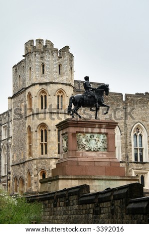 English Medieval Castle in the rain with  Statue of a Horse and Rider in the Foreground