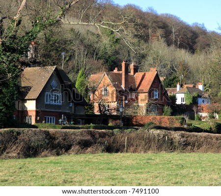 Traditional English Rural Cottages at the base of Wooded Hillside