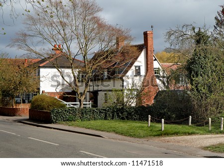 English Village Street with a Timber Framed House with stormy clouds above