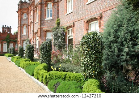 View of an English Manor with neat garden bordered with Box Hedging