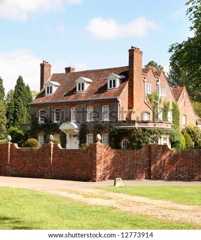 English Country Manor House surrounded by a high red brick wall