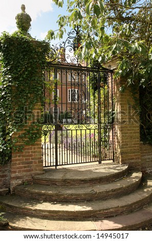 Wrought Iron gated entrance and stone steps to an Historic English House
