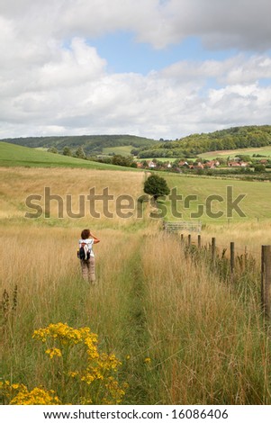 Mature Lady Hiker on an English country path viewing the Landscape