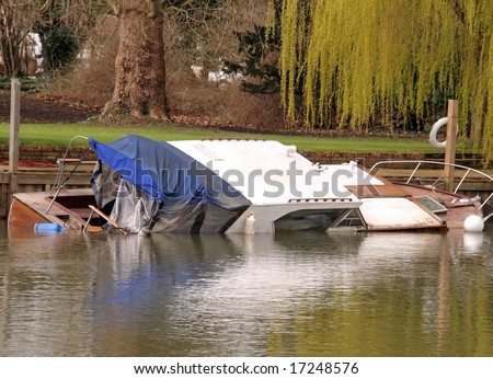A Boat sunk at its moorings on the River Thames in England