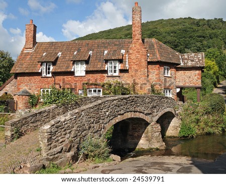 English Country Cottage with bridge over a stream