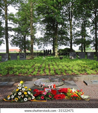 Langermark World War One German Military cemetery in Flanders, Belgium with flowers and wreaths on the ground