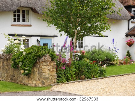 Whitewashed Thatched English Village Cottage and garden