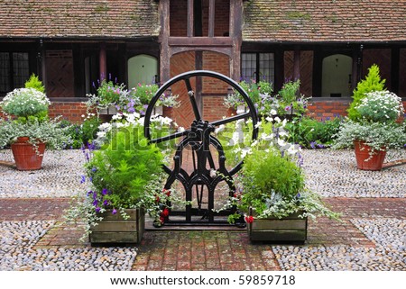 Medieval Cobbled English Courtyard Garden with Well in the center
