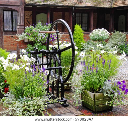 Medieval Cobbled English Courtyard Garden with Well in the center