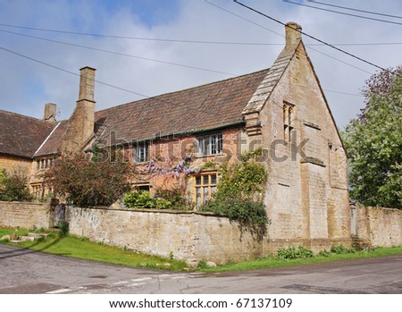 Traditional English Village Cottage and garden with Climbing Wisteria on the Wall