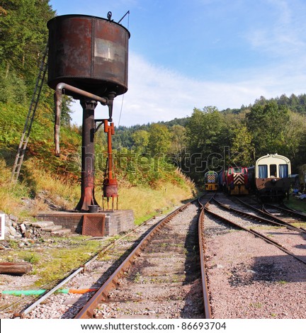 Old steam railway tracks and vintage diesel Locomotives with rusting Water Tower