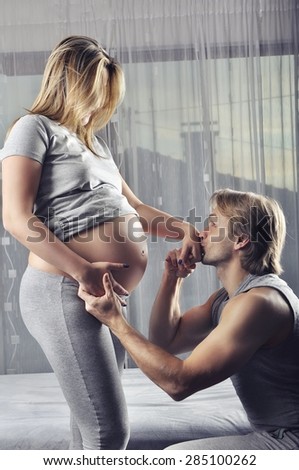 Happy future daddy kissing his wife\'s hand