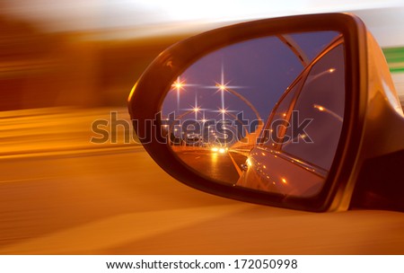 Reflection of high-speed road on car\'s mirror