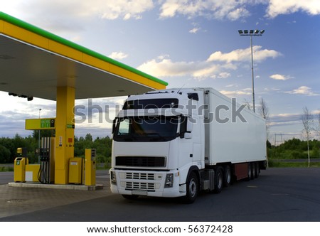 White truck is at a fuel station.