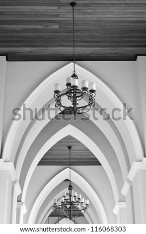 arched ceiling of church with chandelier
