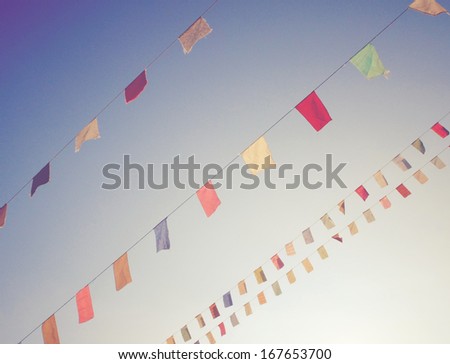 Colorful Bunting Flags On Blue Sky With Retro Filter Effect