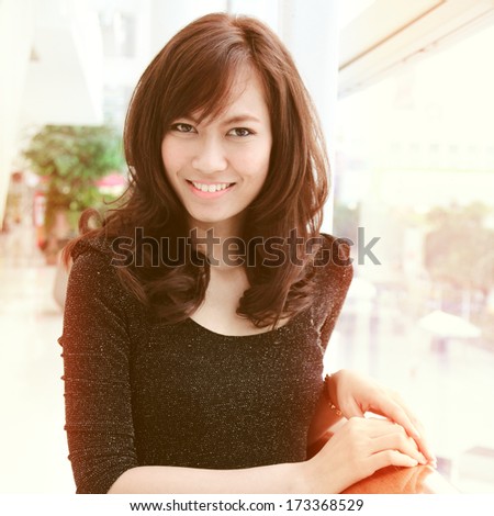 Portrait of young pretty asian woman smiling with retro filter effect