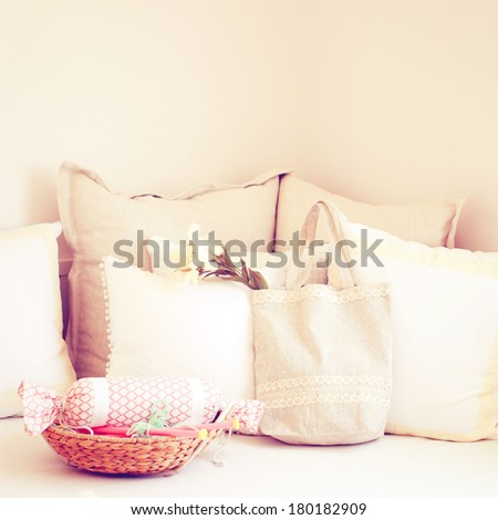 Knitting needles in basket and cute tote bag on the bed with retro filter