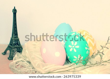 Colorful easter eggs and eiffel tower model with retro filter effect