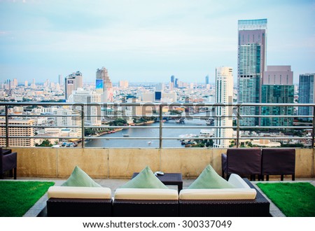 BANGKOK, THAILAND, JULY 25, 2015: Restaurant couch bar with view of Bangkok Cityscape at the Three Sixty  Lounge of Millennium Hilton Bangkok Hotel in Bangkok, Thailand.