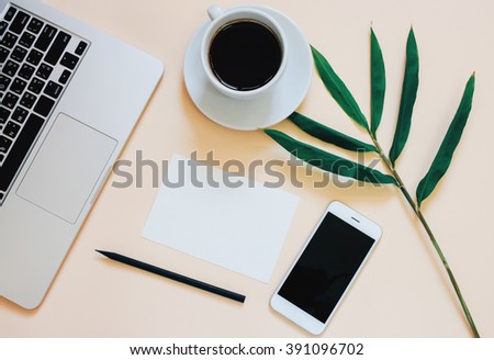 Creative flat lay photo of workspace desk with laptop, smartphone, coffee and blank paper with copy space background, minimal style