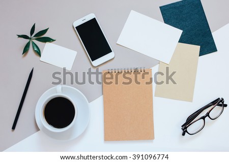 Creative flat lay photo of workspace desk with smartphone, coffee, tag, letter and notebook with copy space background, minimal style