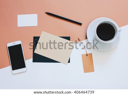 Creative flat lay photo of workspace desk with smartphone, coffee, tag and letter with copy space background, minimal styled