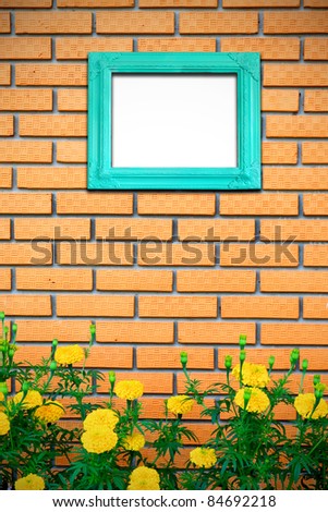 Vintage picture frame on brick wall with yellow flower