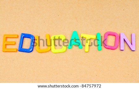 Education in colorful toy letters on paper background