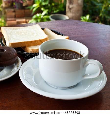 cup of coffee and bread on table