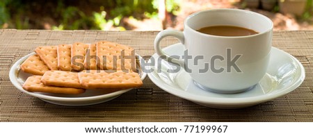 cup of coffee and bread on plate