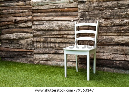 A white wood chair in living room on green grass